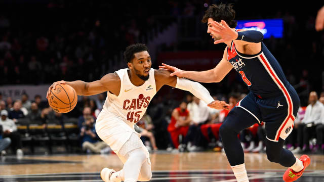 Feb 7, 2024; Washington, District of Columbia, USA; Cleveland Cavaliers guard Donovan Mitchell (45) dribbles as Washington Wizards forward Deni Avdija (8) defends during the first half at Capital One Arena.